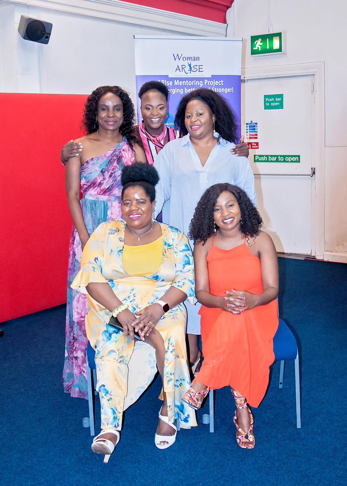 Woman Arise members smiling together at an event